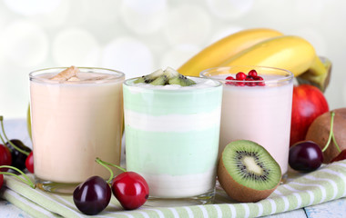 Delicious yogurt with fruits tastes in glasses and fresh fruits