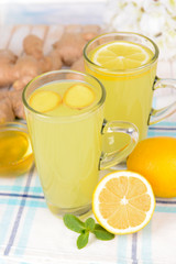 Healthy ginger tea with lemon and honey on table close-up