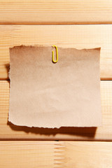 Empty paper sheet on wooden background