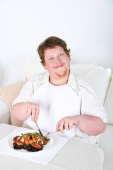 Tasty lunch for fat man, on home interior background