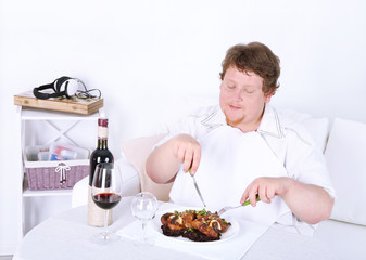 Tasty lunch for fat man, on home interior background