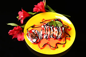 Tasty cake with cream, on black background © Africa Studio