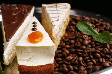 Assortment of pieces of cake, on dark background © Africa Studio