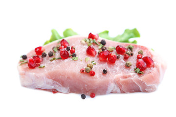 Raw meat steak with leaf lettuce, spices and pomegranate seeds,