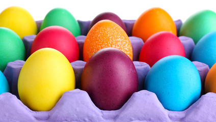 Fototapeta na wymiar Colorful Easter eggs in tray close up