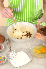 Woman preparing Easter cake in kitchen