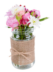 Beautiful bouquet of bright flowers in jar isolated on white
