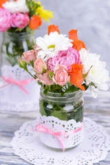 Beautiful bouquet of bright flowers in jars