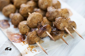 Close-up of baked champignons kebabs, horizontal shot