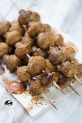 Baked champignon kebabs, vertical shot, close-up