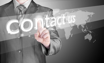 businessman hand pushing contact us button
