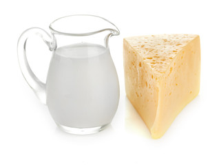 Big piece of cheese, glass jug with milk