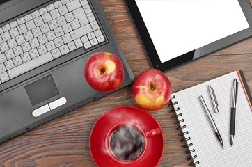 Laptop and office supplies on wooden table