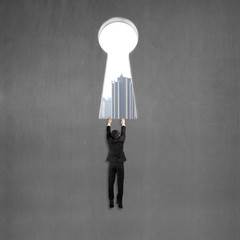 Climbing to key shape door with city view