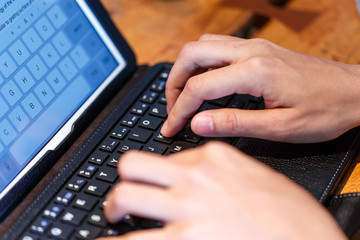 Female fingers typing on keyboard