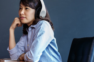 Young woman using  wireless headphone