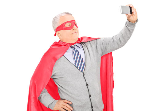 Masked mature man taking a selfie