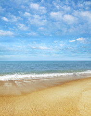 Fototapeta na wymiar Golden sand, blue sea and sky. Beach