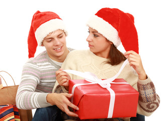 couple in Santa hats with presents isolated on white background