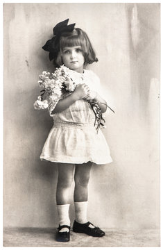 antique photo portrait of little girl with flowers. Mother's Day