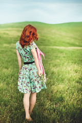 Girl standing on the green grass