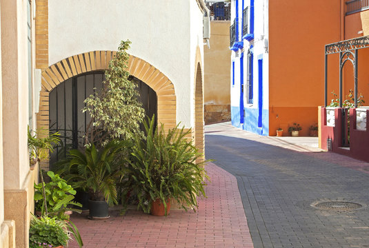 Spanish holiday apartments & street in traditional pastel colour