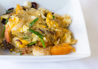 Vermicelli fried with vegetable, egg and shrimp on dish