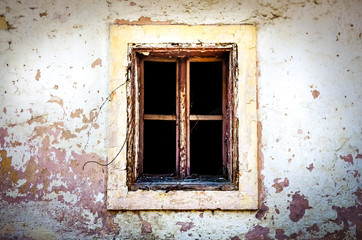 Old damaged window on textured wall