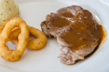 Grilled steaks, baked potatoes,fried onion