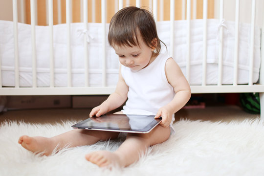 baby with tablet PC at home