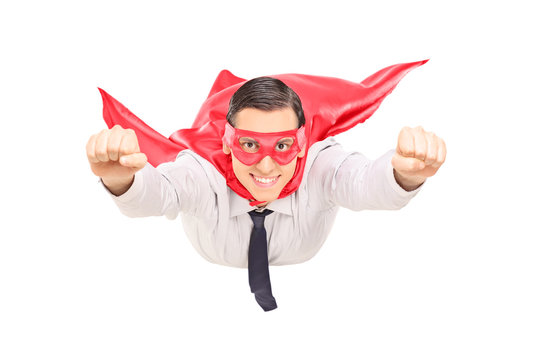 Superhero with red cape flying