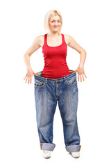 Woman standing in a pair of oversized jeans
