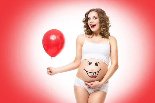 Pregnant woman holding balloon