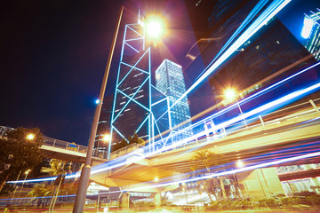 Road light trails on modern city buildings backgrounds in HongKo