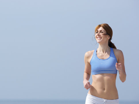 Smiling woman jogging outdoors