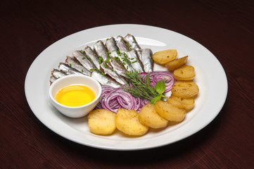 The menu photo - the plate full of sprat-fish with potatos
