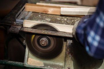Old carpenter working with wood