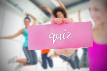 Fit blonde holding card saying quiz