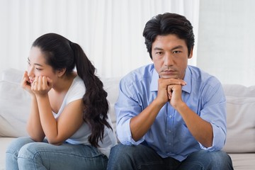 Couple not talking after a dispute on the sofa