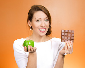 Apple over chocolate healthy life choices decision concept 