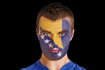 Composite image of serious young bosnian fan with facepaint