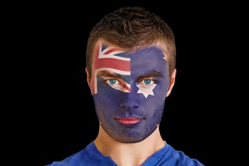 Composite image of serious young australia fan with facepaint