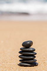 Fototapeta na wymiar Zen kamienie JY na piaszczystej plaży w pobliżu morza.