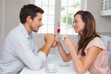 Loving couple holding hands at home
