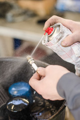 Spark plug cleaning in repair shop.