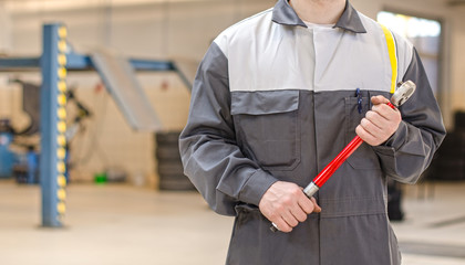 Mechanic with torque wrench at auto repair shop.