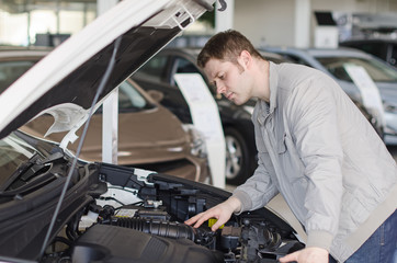 Man examining new car at the dealership.