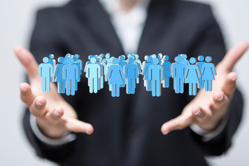 group 3d -  Businessman holding 3D rendering group of blue people 