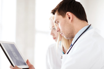 two doctors looking at x-ray on tablet pc