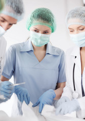 young group of doctors doing operation